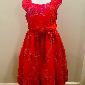 A red flower dress with puffy sleeve, is in very good condition.